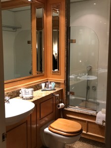 Bathroom with wood panelling and granite counter top.